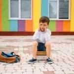 A young boy shows school refusal behavior.