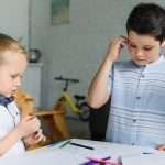 Two young boys bond over puzzles.